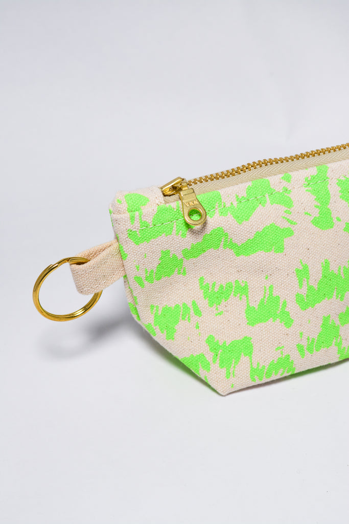 Small pouch with green pattern and gold zipper on a light gray background