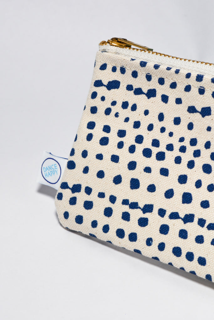 Pouch with blue dot pattern on a white background